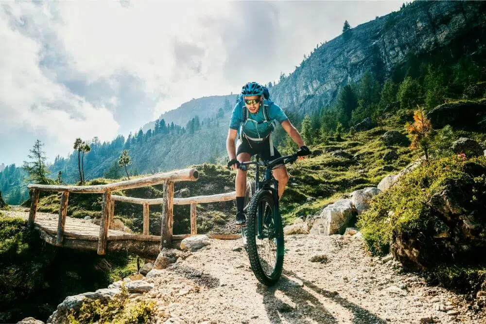Are Mountain Bikes Good for Commuting? 2 crossing a bridge with a mountain bike